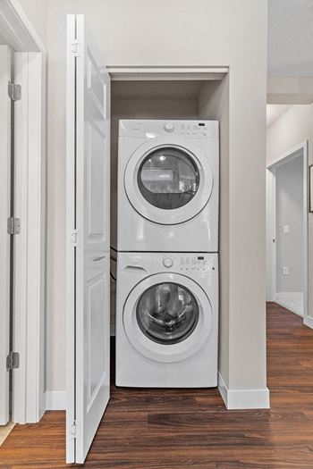 a white washer and dryer in a small closet